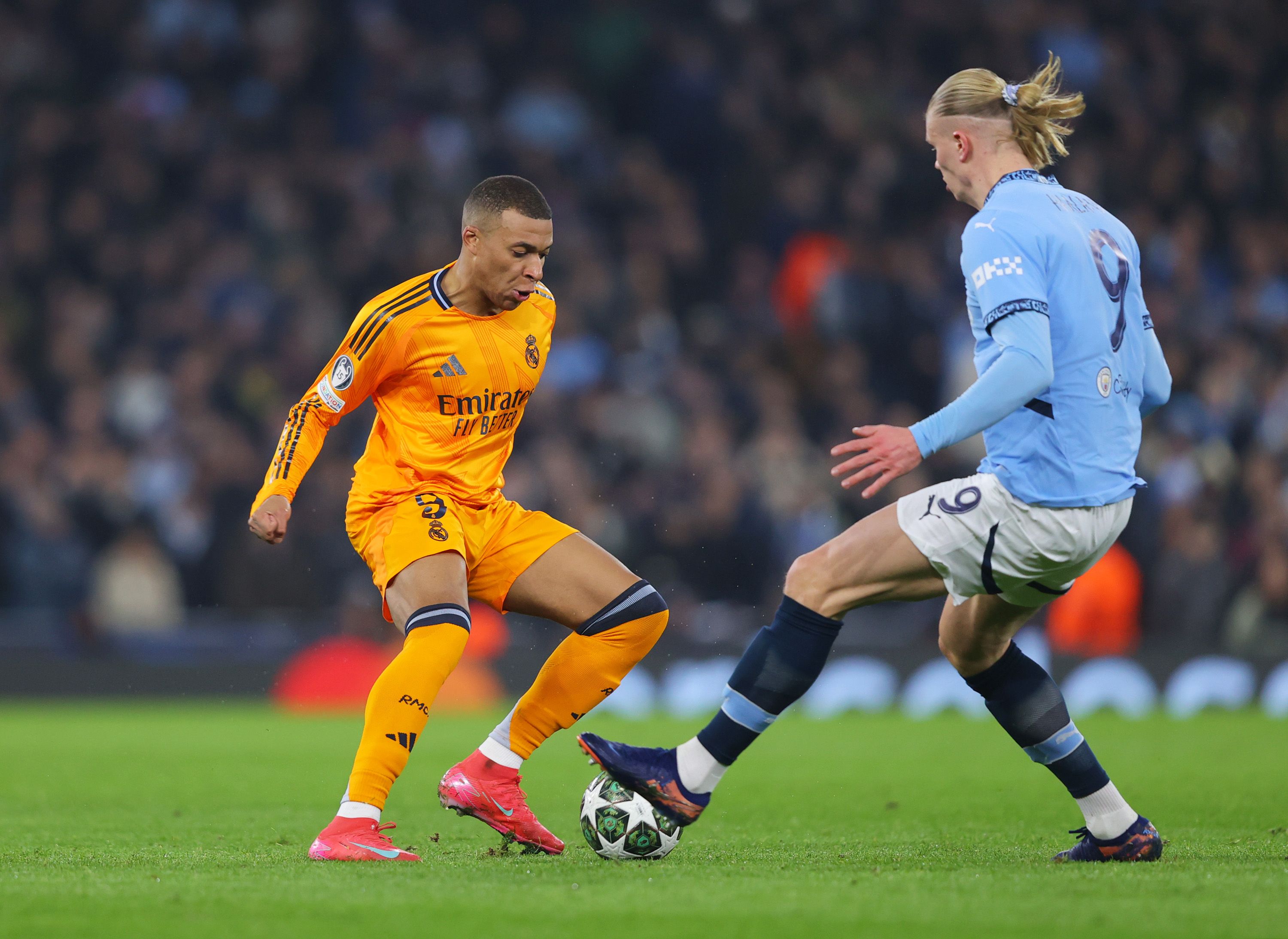 Mbappe challenged by a City defender